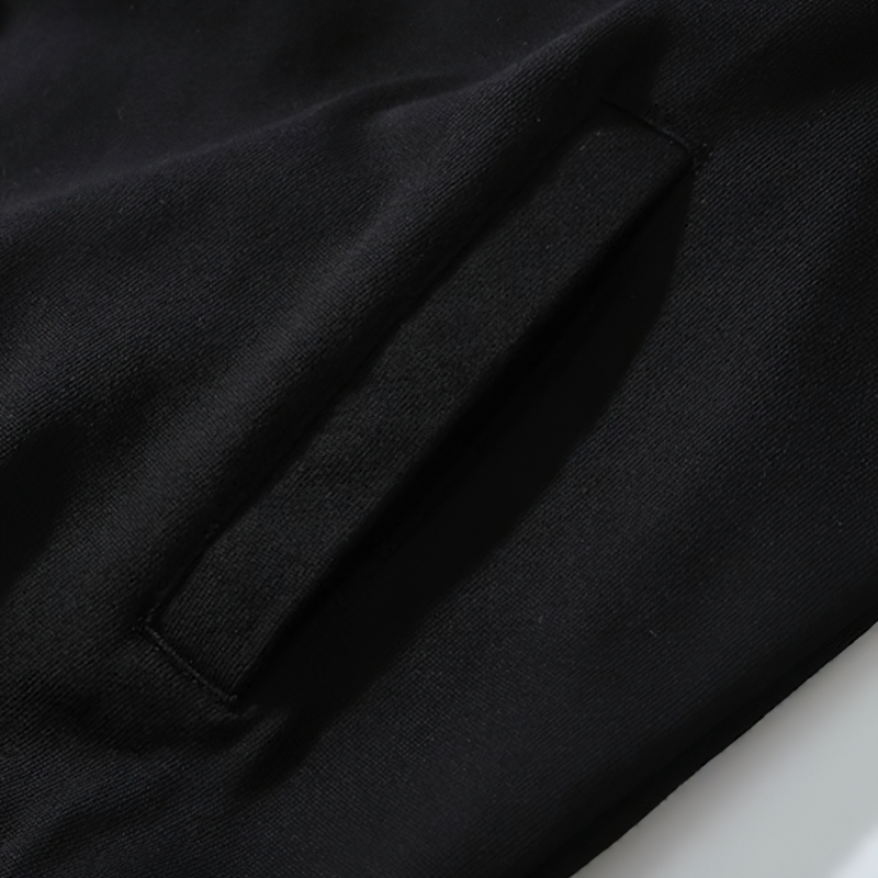 Close-up of the pocket detail on a black oversized zipper hoodie for men, showcasing casual punk style.