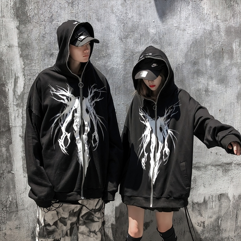 Oversized black zipper hoodie with punk graphic print on two models, perfect for casual street style.