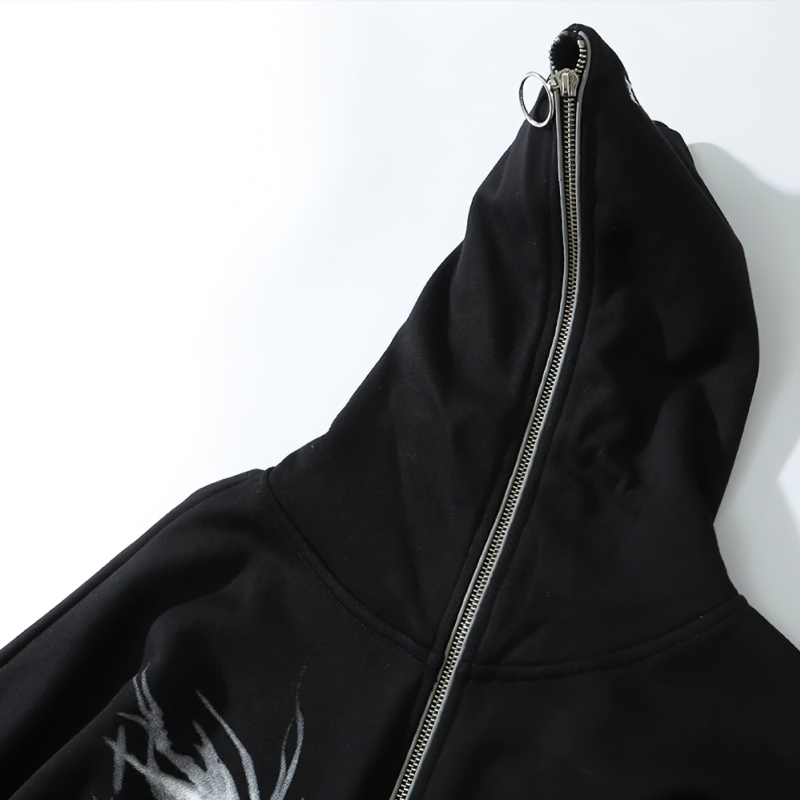 Close-up of a black oversized men's zipper hoodie featuring punk graphic print and stylish metal zipper.