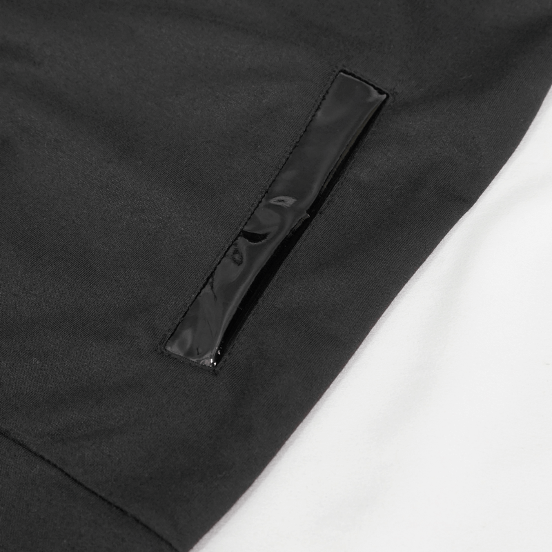 Close-up of glossy black patent leather detail on men's black sleeveless hoodie, showcasing gothic fashion style.