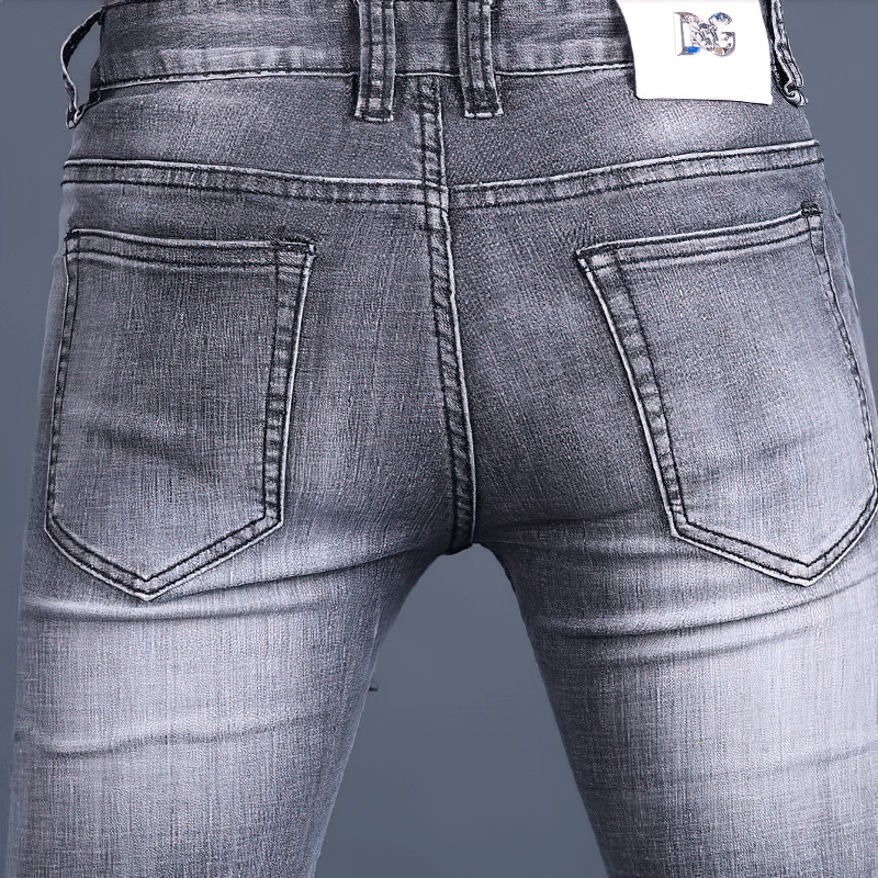 Men's skinny jeans with stylish embroidery and a casual fit, showcasing a close view of the back pockets.