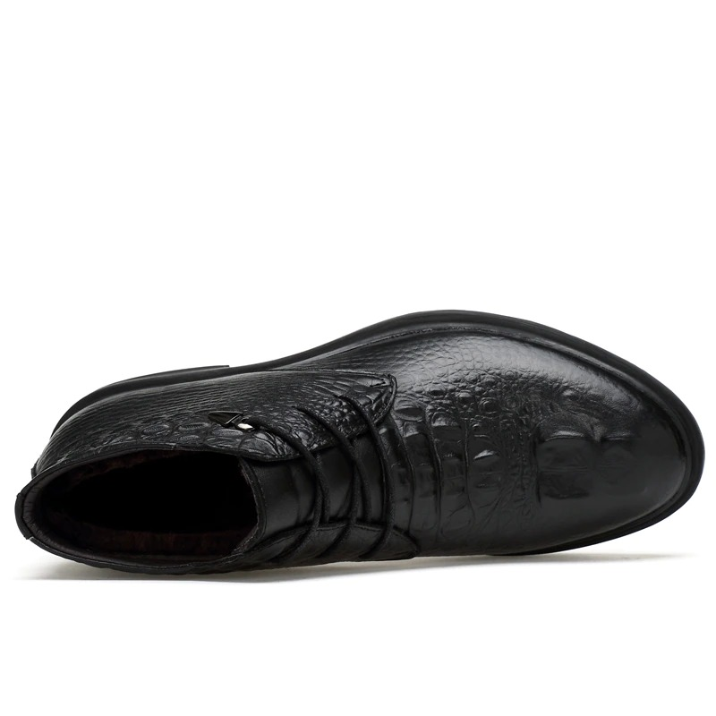 Top view of men's warm genuine leather black ankle boots with lace-up design and stylish texture.