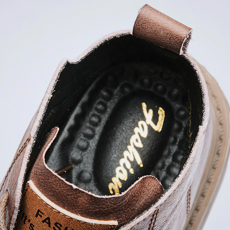 Inside view of stylish men's ankle leather boot showcasing quality craftsmanship and cushioned insole.