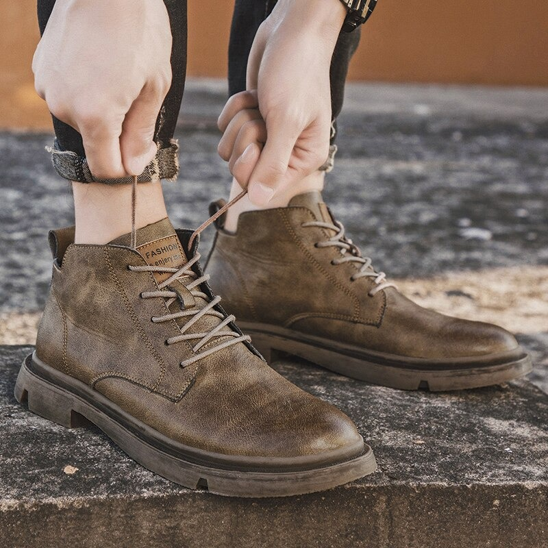 Stylish men's ankle leather boots in brown, perfect for casual wear and showcasing non-slip rubber soles.