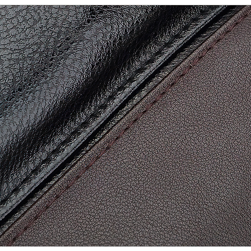 Close-up of high-quality black PU leather texture showcasing stitching detail for a stylish backpack.