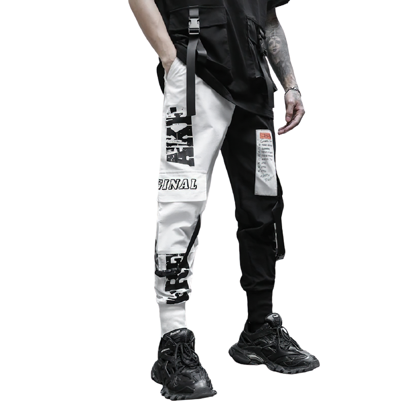 Stylish men's black and white patchwork cargo pants with pockets, perfect for a trendy casual outfit.