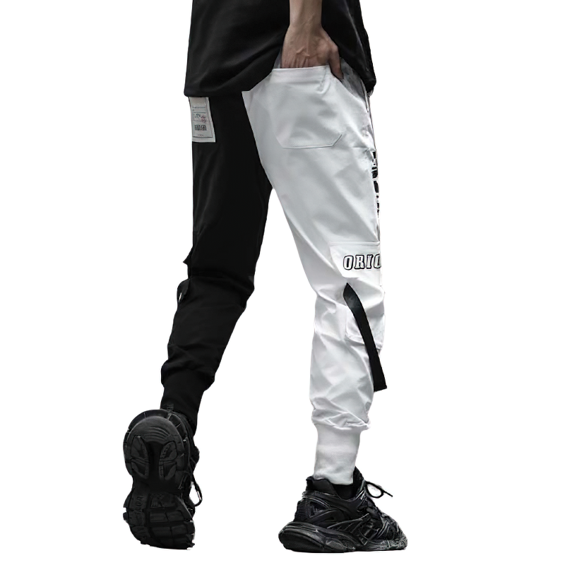 Men's black and white patchwork cargo pants with pockets for a casual look, perfect for an alternative wardrobe.