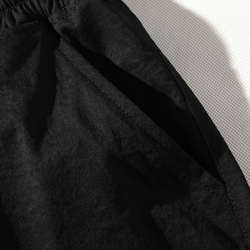 Detail of men's elastic waist shorts showing pocket and fabric texture, perfect for casual everyday wear.