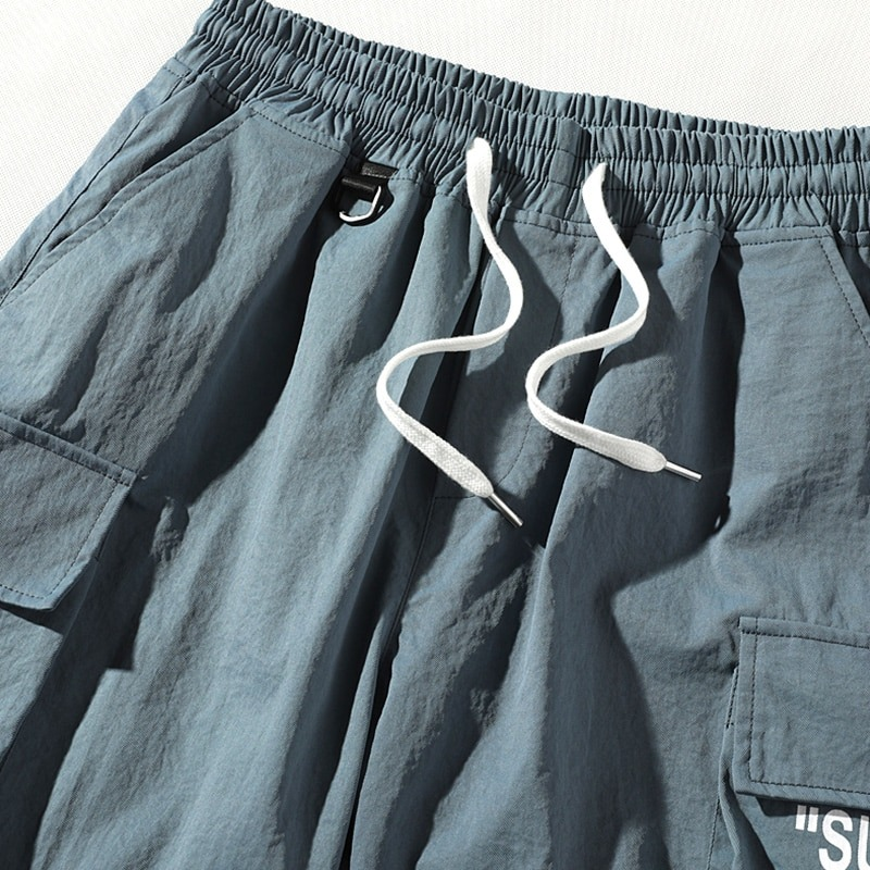 Men's stylish elastic waist shorts in blue with pockets and drawstring for casual wear.