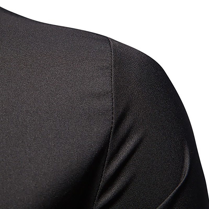 Close-up of the shoulder and sleeve of a black men's long-sleeved shirt made from breathable fabric.