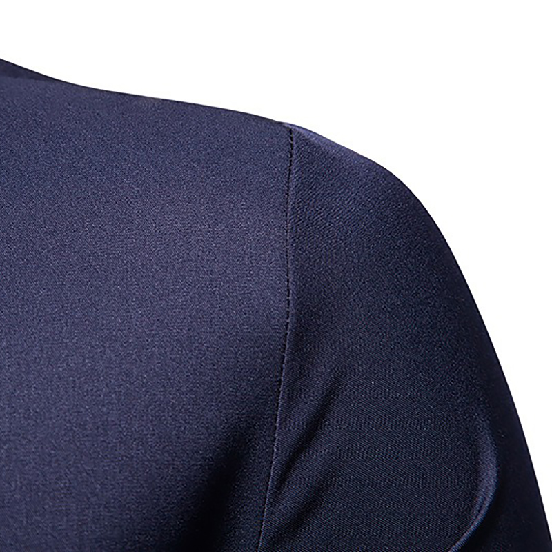 Close-up of the shoulder seam of a men's asymmetric long-sleeved shirt in navy blue, showcasing its quality fabric.