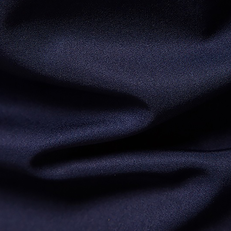 Close-up of smooth navy fabric showcasing the quality of our men's embroidered asymmetric shirt.