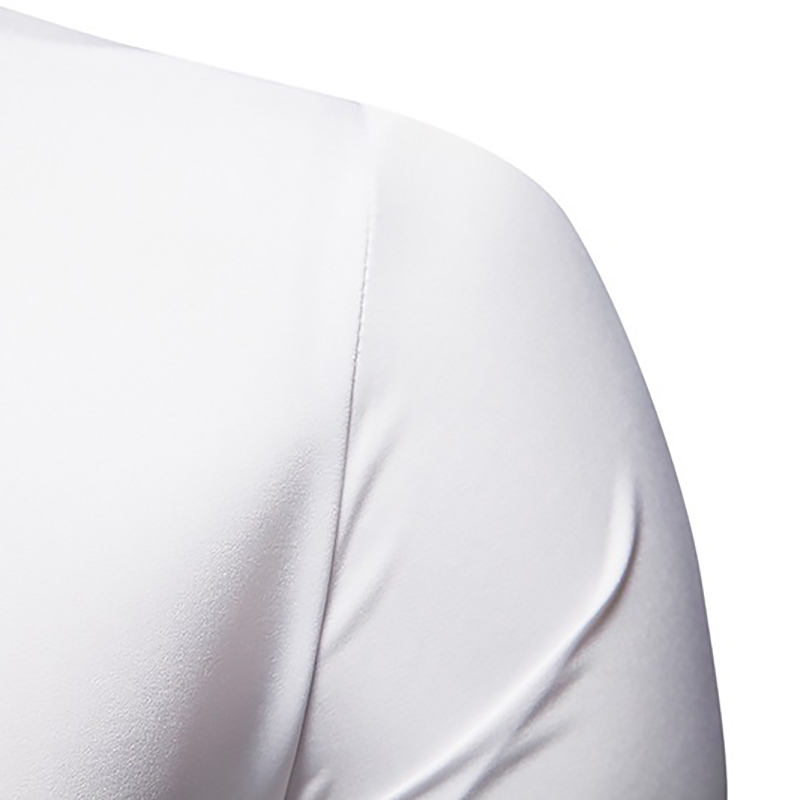 Close-up of the shoulder area of a men's white asymmetrical long-sleeved shirt made of breathable fabric.