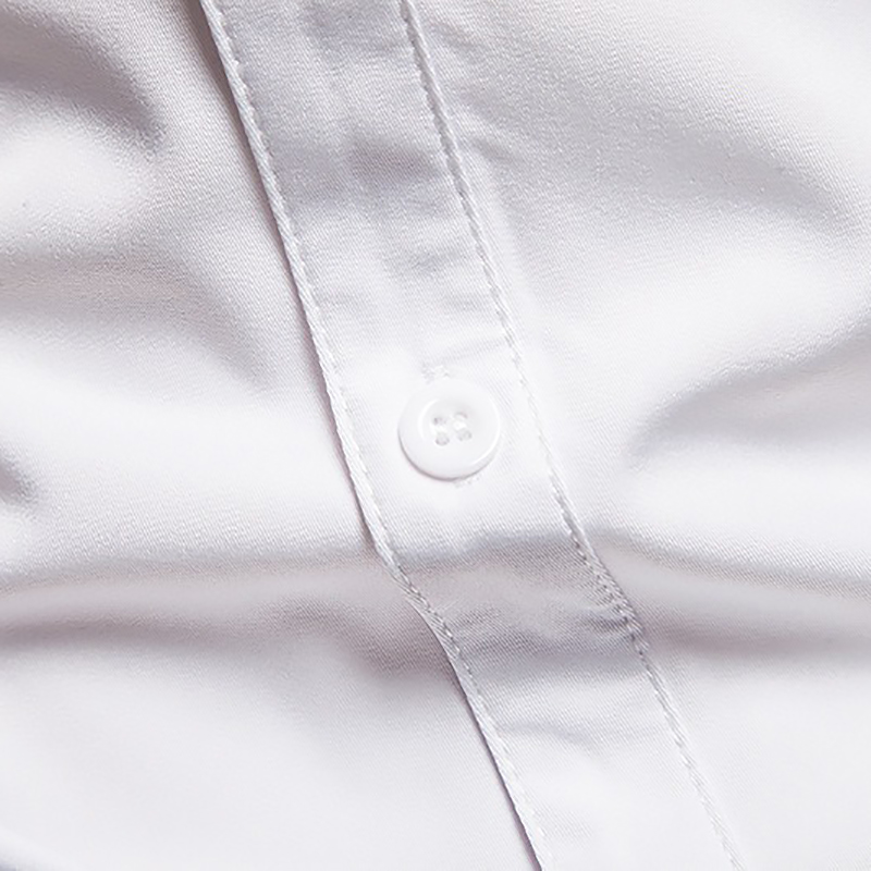Close-up of white cotton shirt button, showcasing the quality and detail in men's casual fashion.