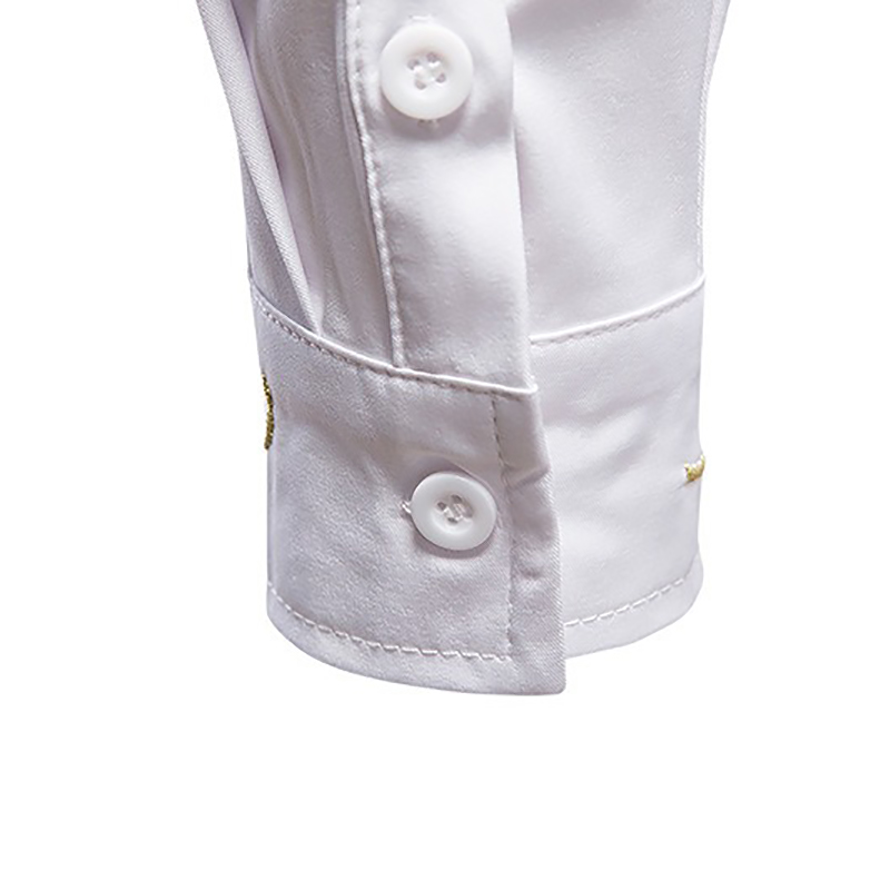 Close-up of the button cuff on a stylish men's asymmetric long-sleeved shirt in white cotton.