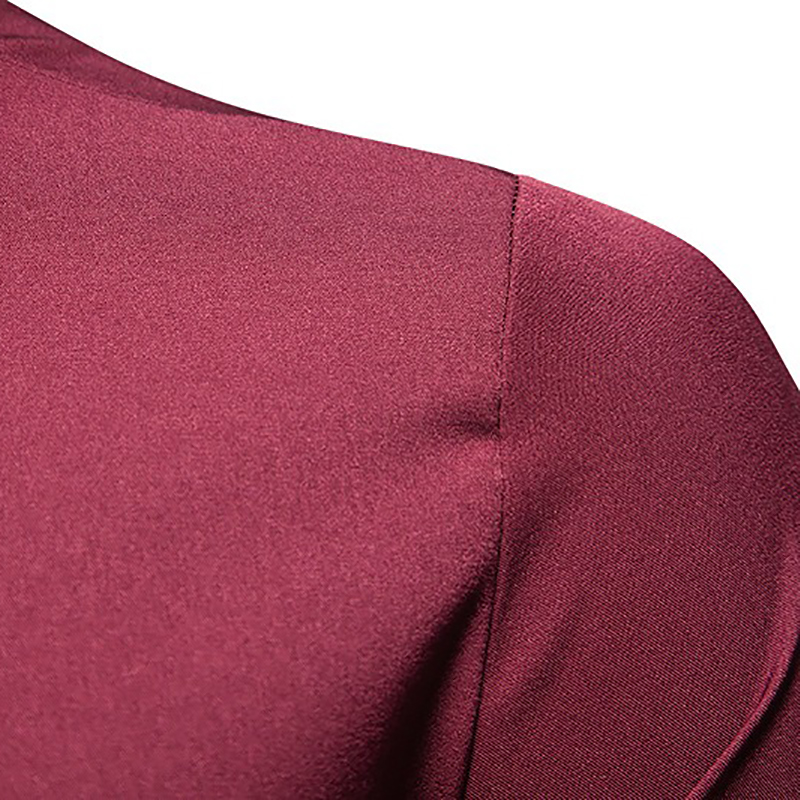 Close-up of a men's maroon asymmetric shirt showcasing smooth fabric and unique design detail.