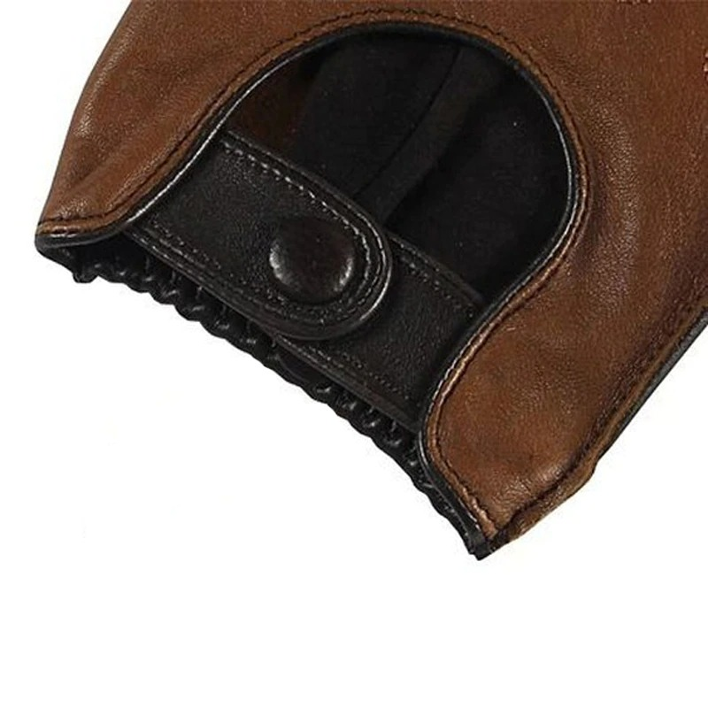 Close-up of men's genuine leather motorcycle gloves in brown with snap closure, showcasing casual biker style.