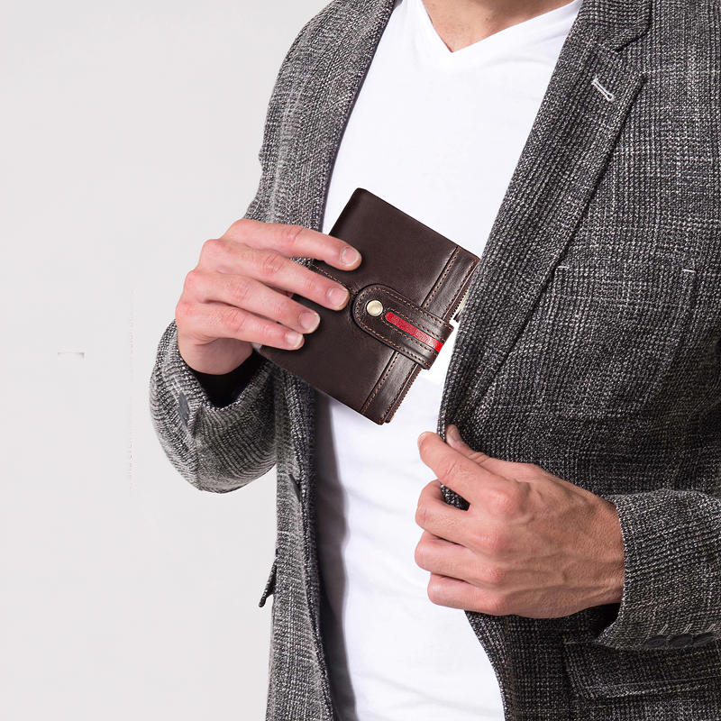 Stylish man pulling out a genuine leather multifunction wallet from his blazer for a trendy look.