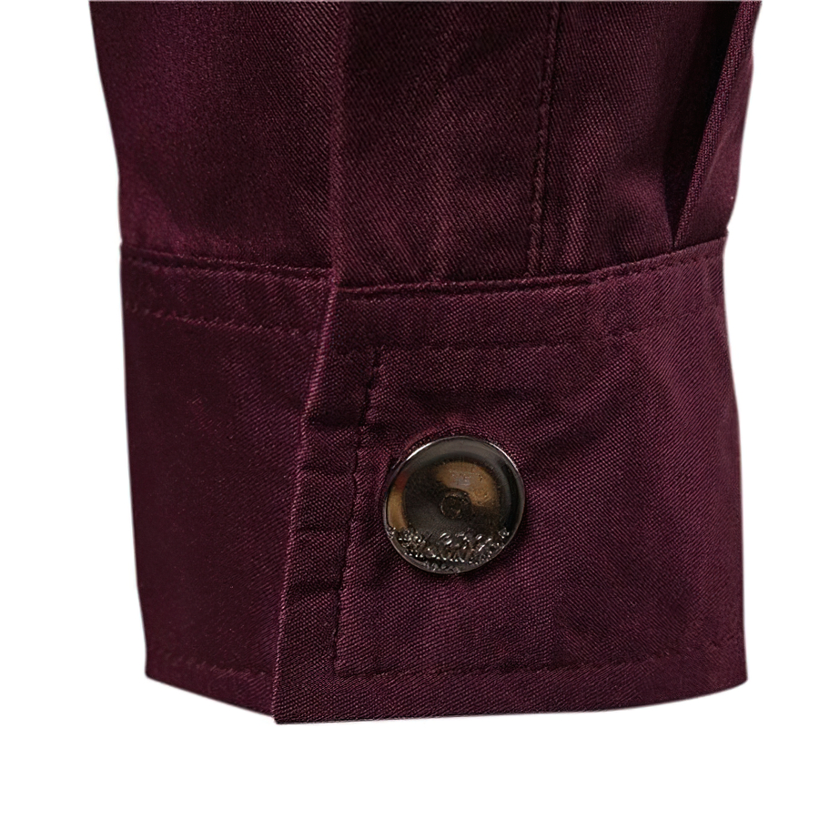 Close-up of the cuff detailing on a burgundy men's long sleeve shirt with rivets for a stylish casual look.