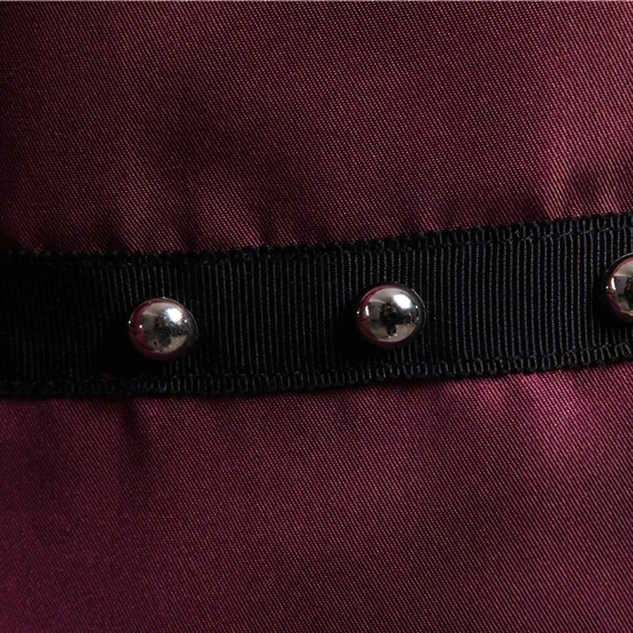 Close-up of men's long sleeve shirt fabric with rivets, showcasing stylish casual design and quality materials.