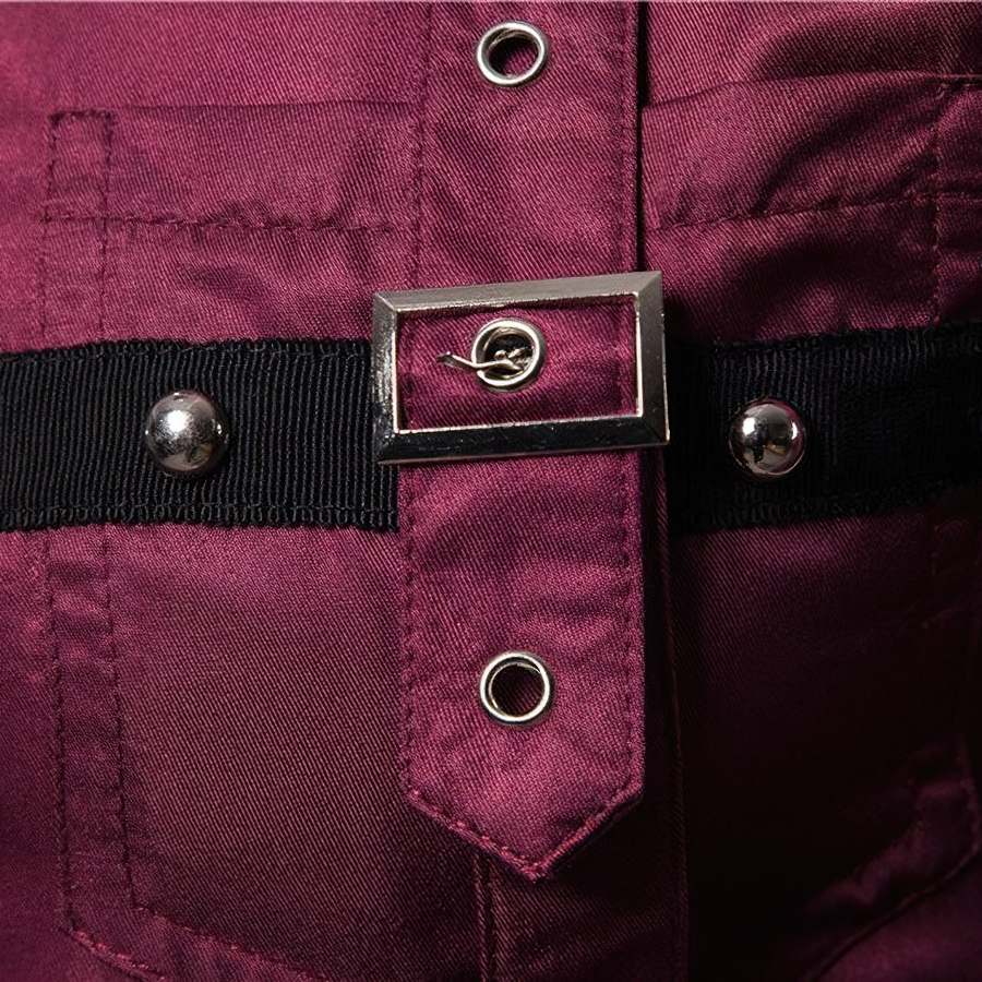 Close-up of stylish rivets and buckle on a men's long sleeve shirt, emphasizing alternative fashion details.