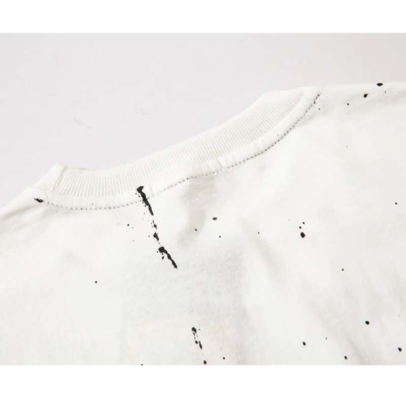 Back view of white punk style sweatshirt featuring unique black ink splatter design for a trendy look.