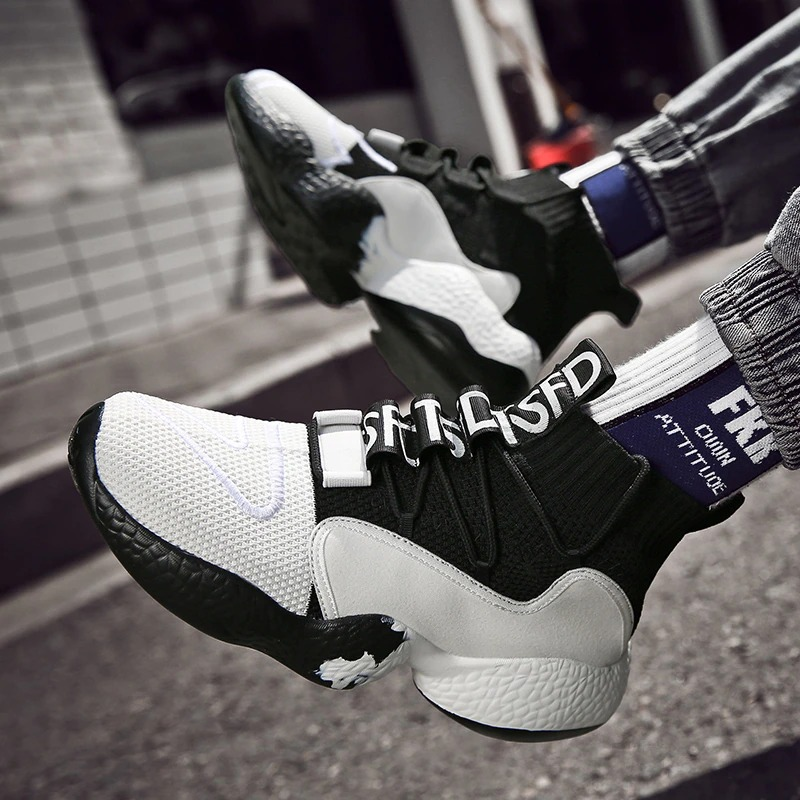 Stylish men's lace-up sneakers in black and white, featuring breathable materials and a modern design for casual wear.