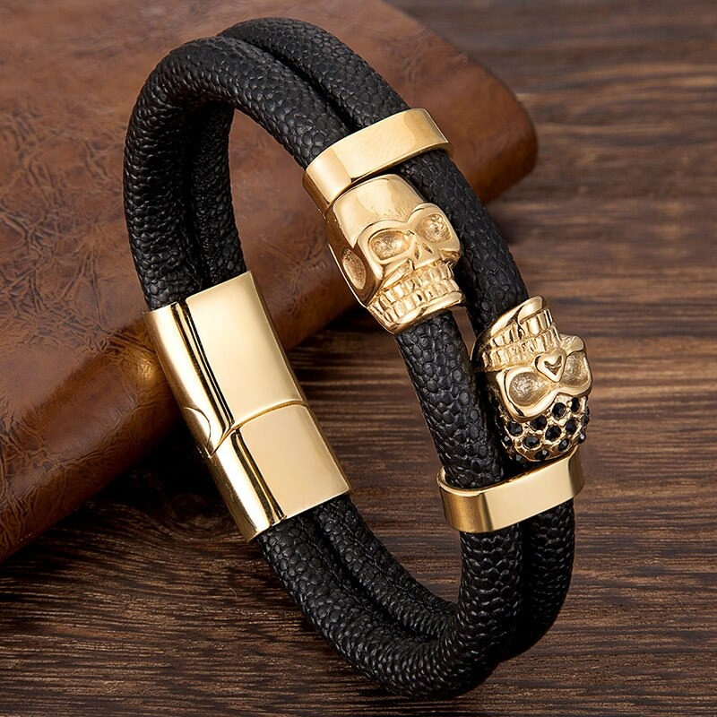 Men's punk style bracelet with gold skull accents on genuine leather, perfect for edgy fashion statements.