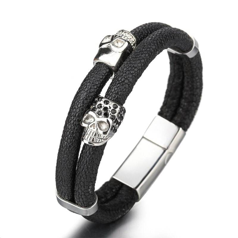 Punk style men's leather bracelet featuring stylish skull accents and a magnetic clasp, perfect for edgy fashion.