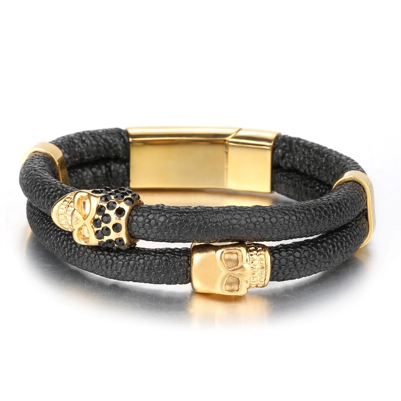 Men's punk style bracelet featuring skulls in gold, made of black genuine leather with a magnetic clasp.