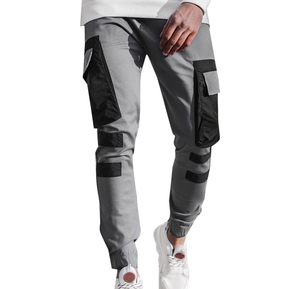 Men's grey streetwear jogger pants with patch pockets, perfect for casual comfort and sporty style.
