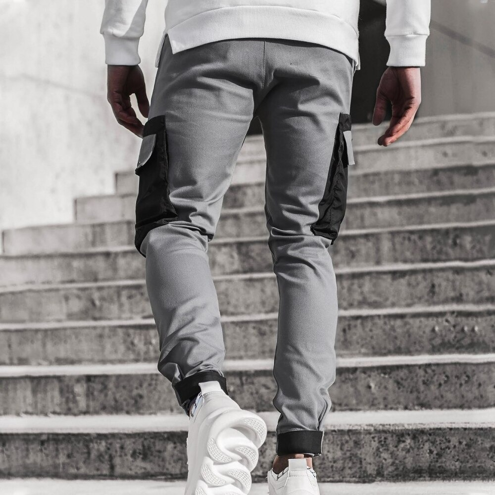 Men's streetwear joggers in gray with stylish patch pockets, perfect for a comfy casual look.