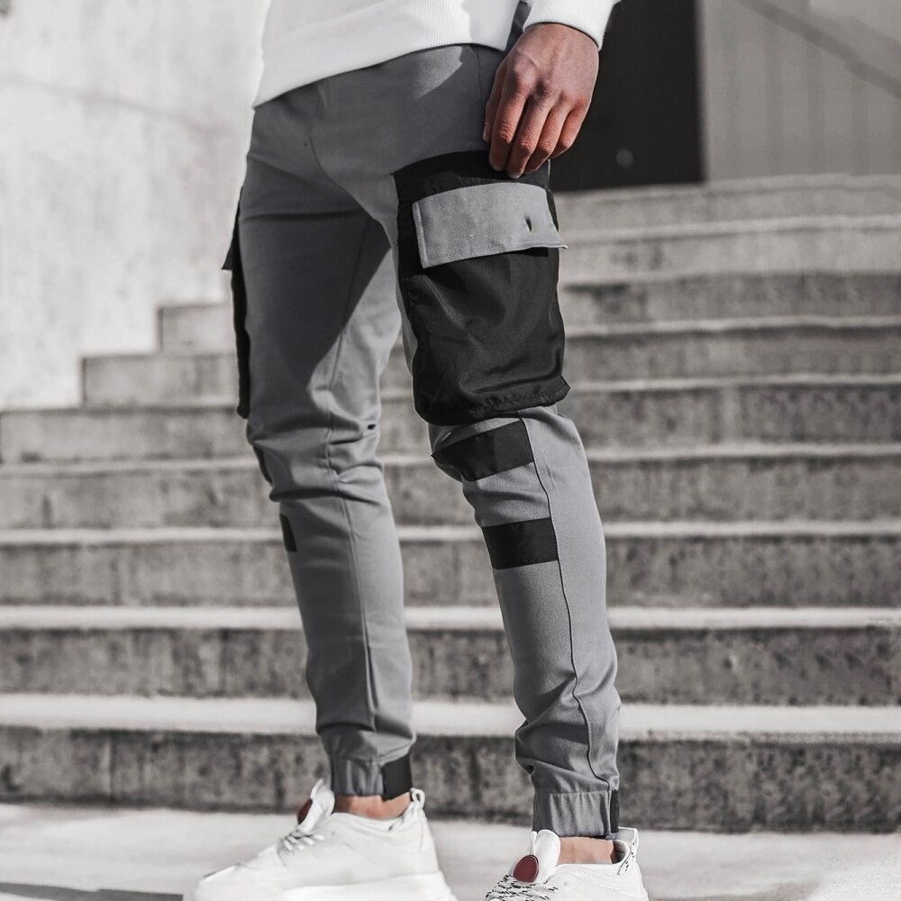 Men's gray jogger pants with black patch pockets, stylish streetwear, perfect for casual outfits and daily wear.