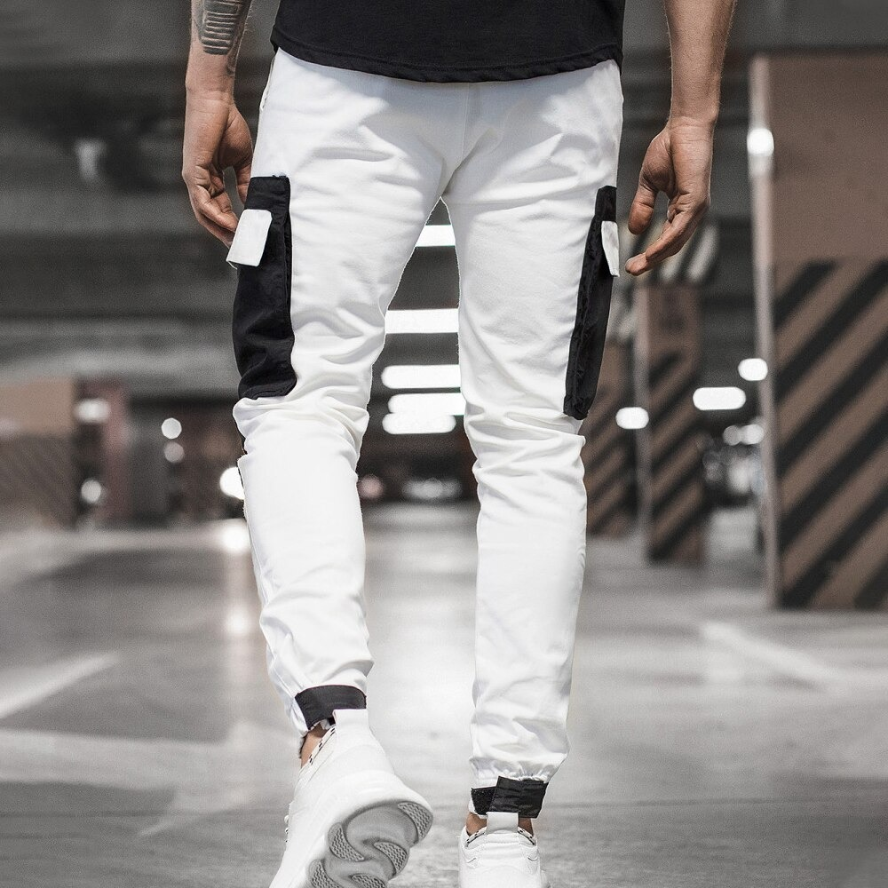 Men's streetwear jogger pants in white with patch pockets, perfect for casual and sporty looks.