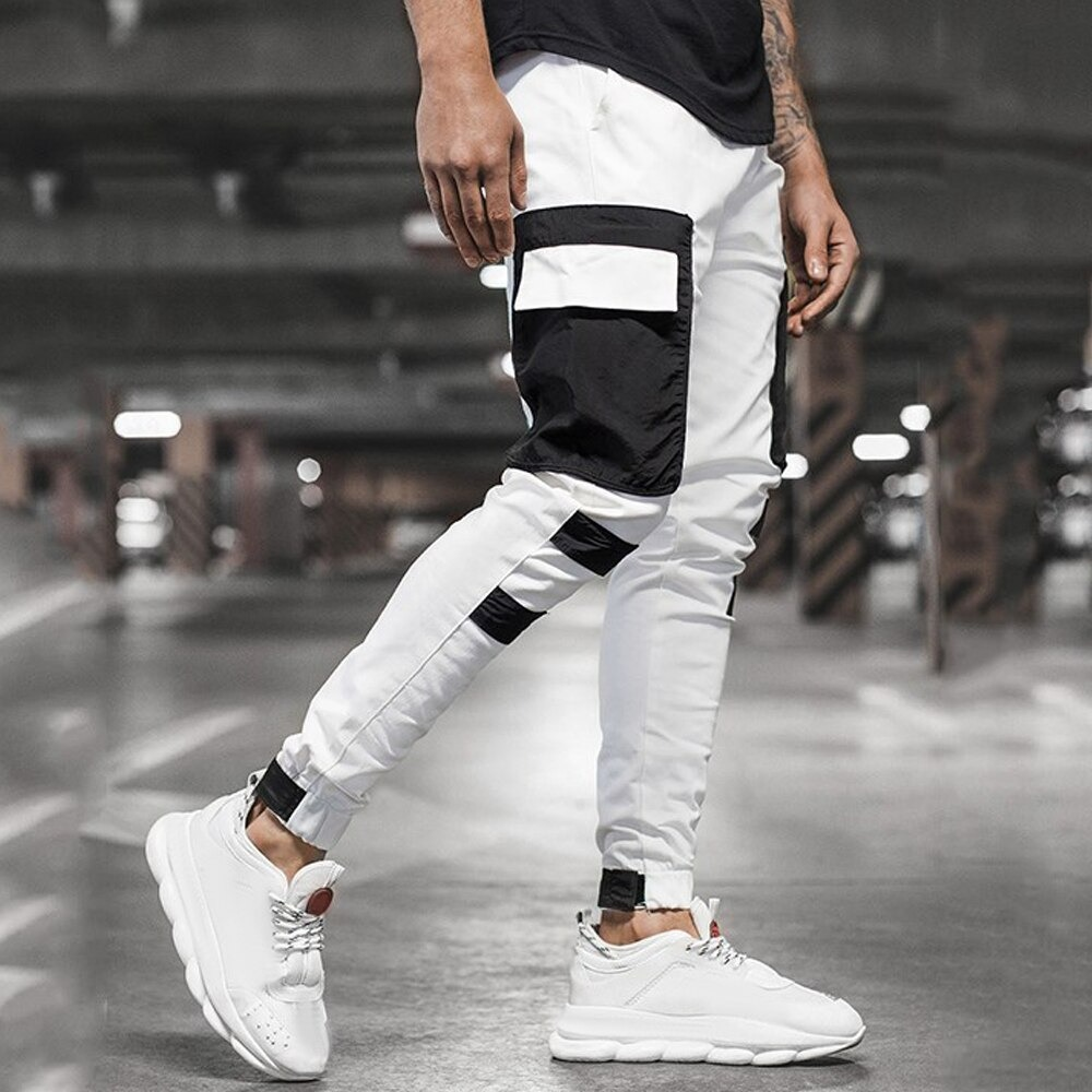 Stylish men's jogger pants in black and white with patch pockets, perfect for casual streetwear fashion.
