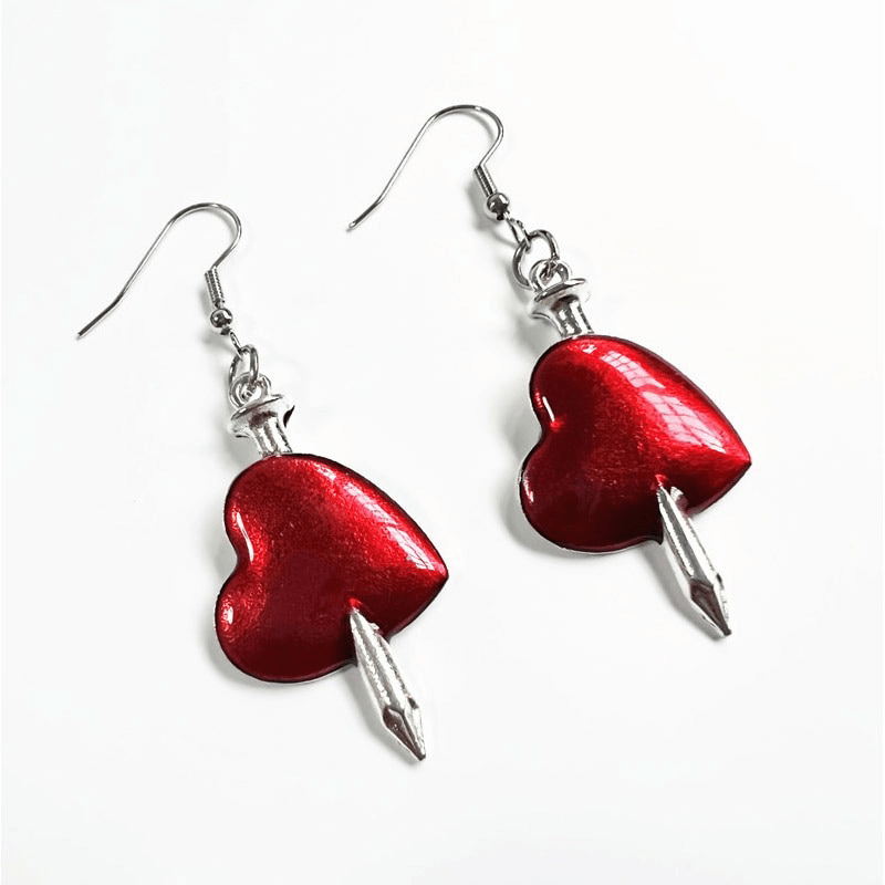 Gothic style red heart earrings with arrow detail, perfect for adding flair to any gothic outfit.