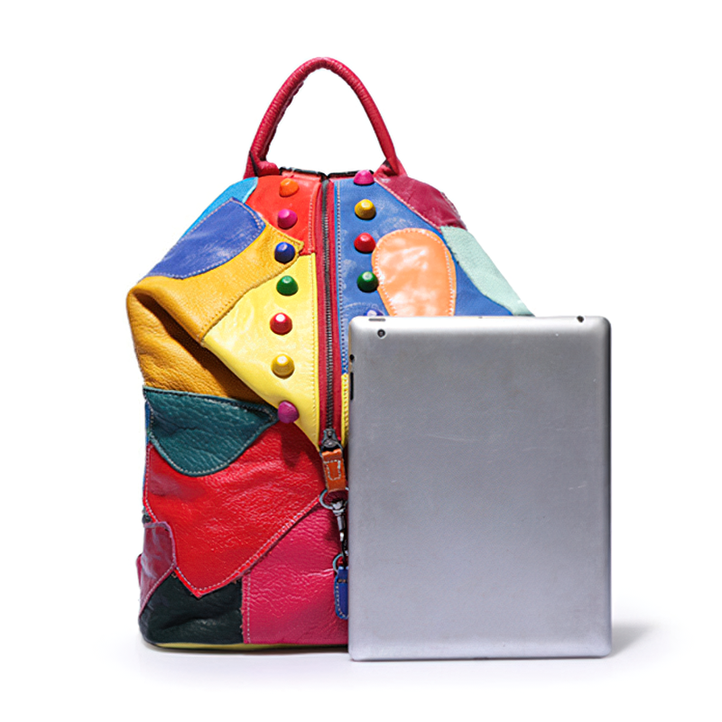 Colorful designer leather backpack next to a tablet, perfect for vibrant fashion and high-capacity storage.