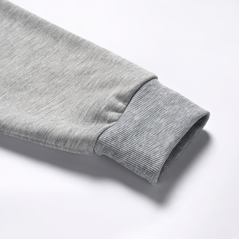 Close-up of the cuff of a gray fleece sweatshirt, showcasing the comfy ribbed design for extra style and warmth.