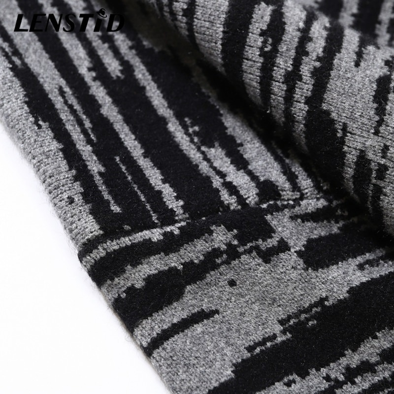 Close-up of a stylish patchwork knitted fabric featuring black and gray stripes, ideal for a trendy oversized sweater.