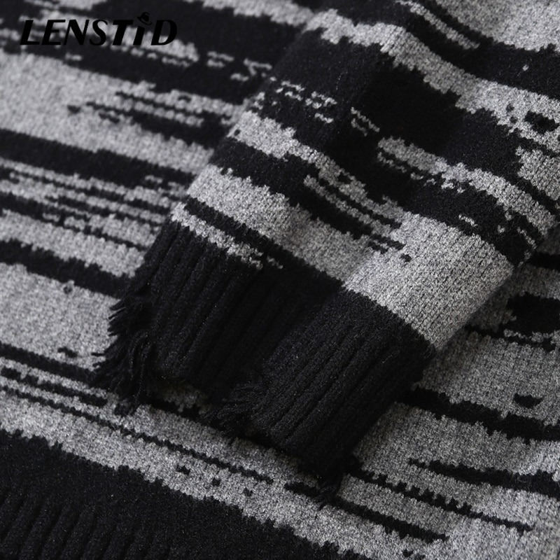 Close-up of a stylish patchwork black and grey knitted oversized sweater, showcasing its comfortable fabric and trendy design.
