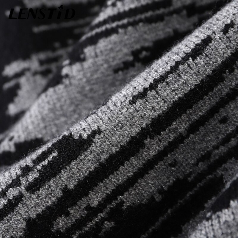 Close-up of black and gray patchwork fabric of a stylish oversized knitted sweater for men.