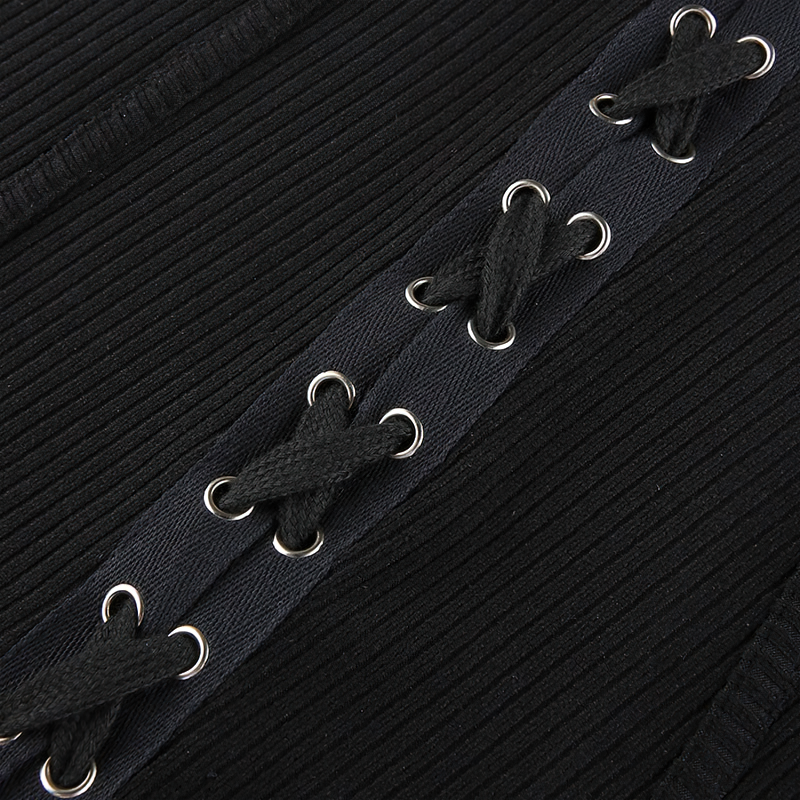 Close-up of black dress lace-up detail, showcasing stylish patches and textured fabric for a trendy look.