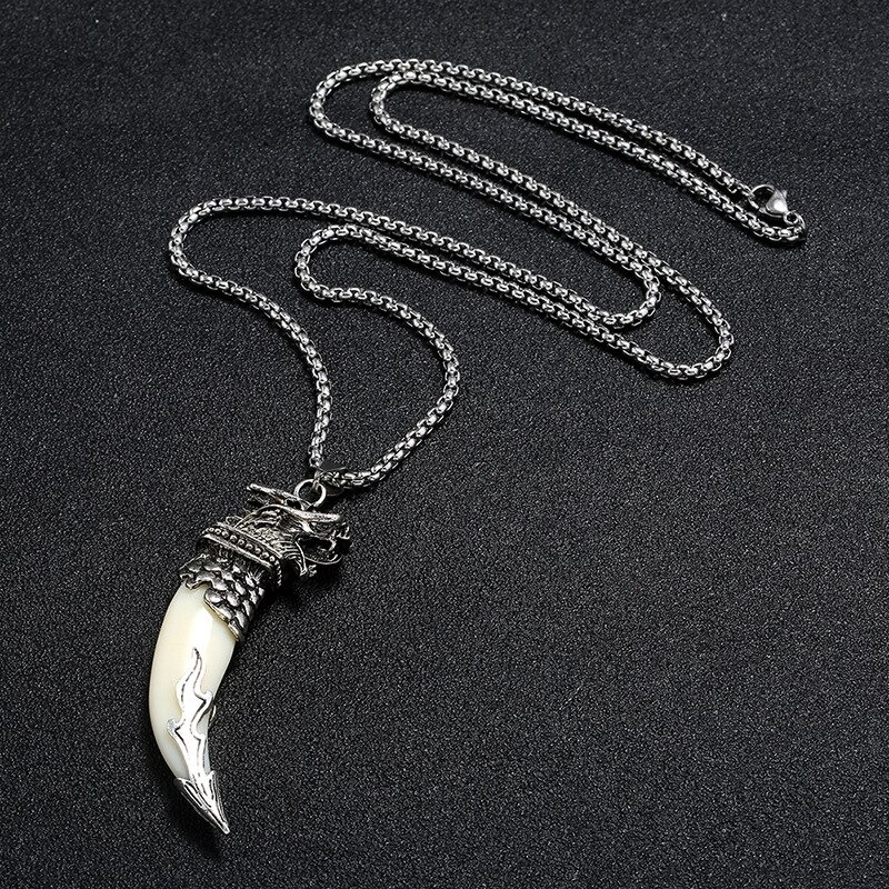 Silver wolf tooth pendant necklace with detailed wolf head, perfect alternative jewelry for men and women.