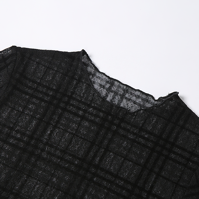 Close-up of the O-neck, plaid pattern on a Gothic style black mini dress with removable sleeves.