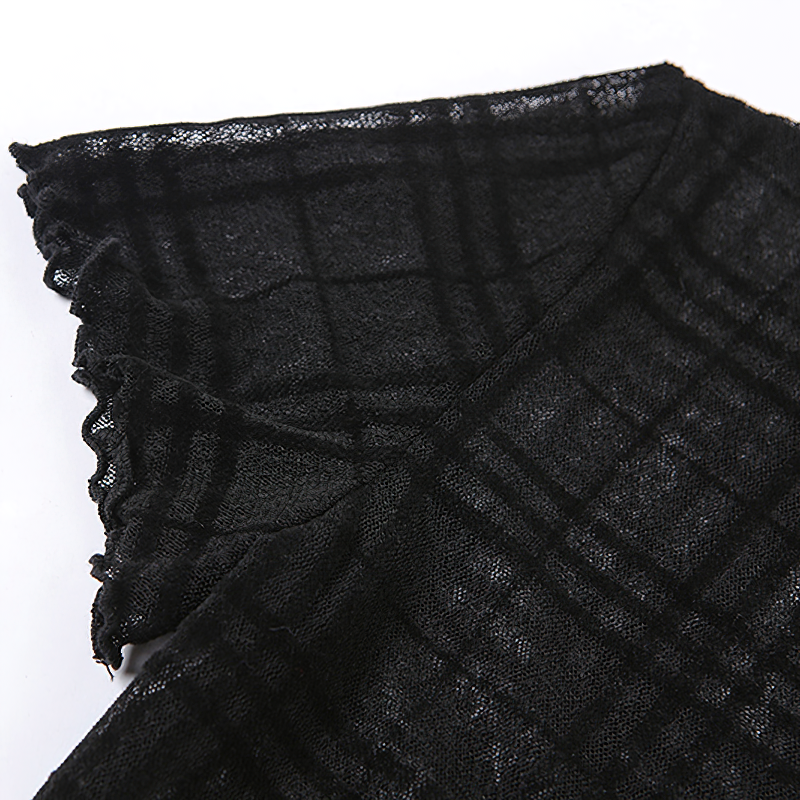 Close-up of black plaid fabric with a frilled edge for a Gothic style mini dress.
