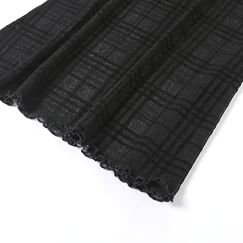 Close-up of black plaid fabric for Gothic style mini dress, showcasing texture and intricate pattern.