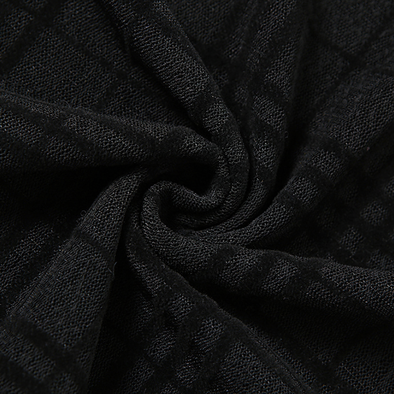 Close-up of black plaid fabric for Gothic-style mini dress, showcasing soft texture and unique pattern.
