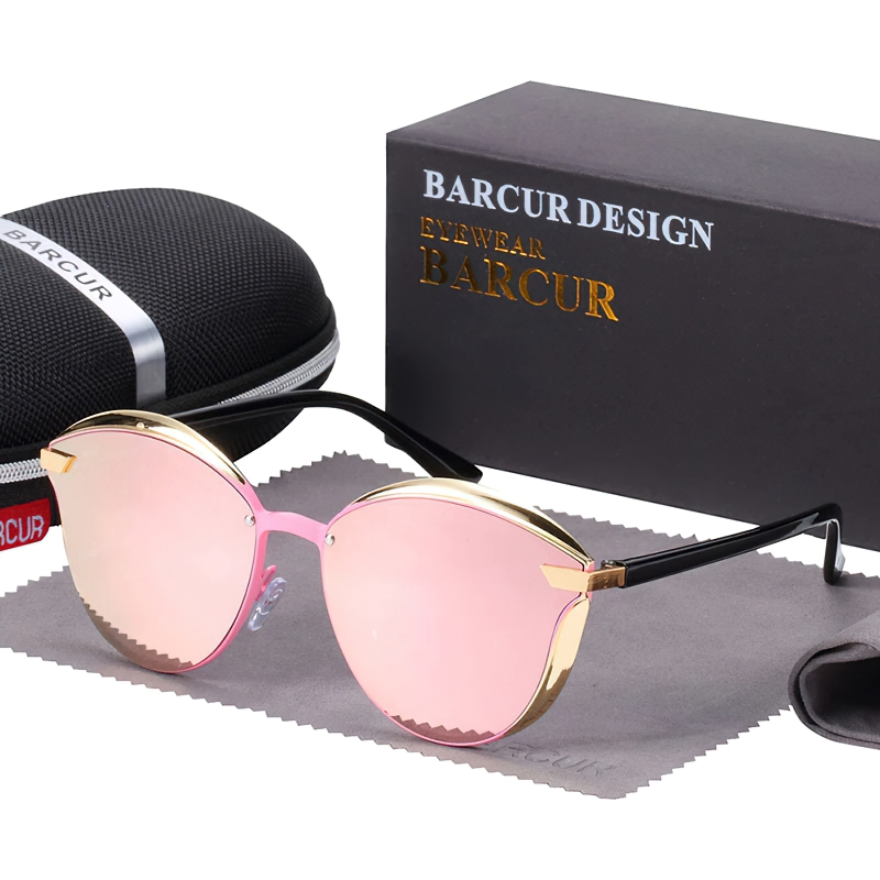Stylish polarized cat-eye sunglasses for women with a pink tint and chic gold accents, in a sleek box.