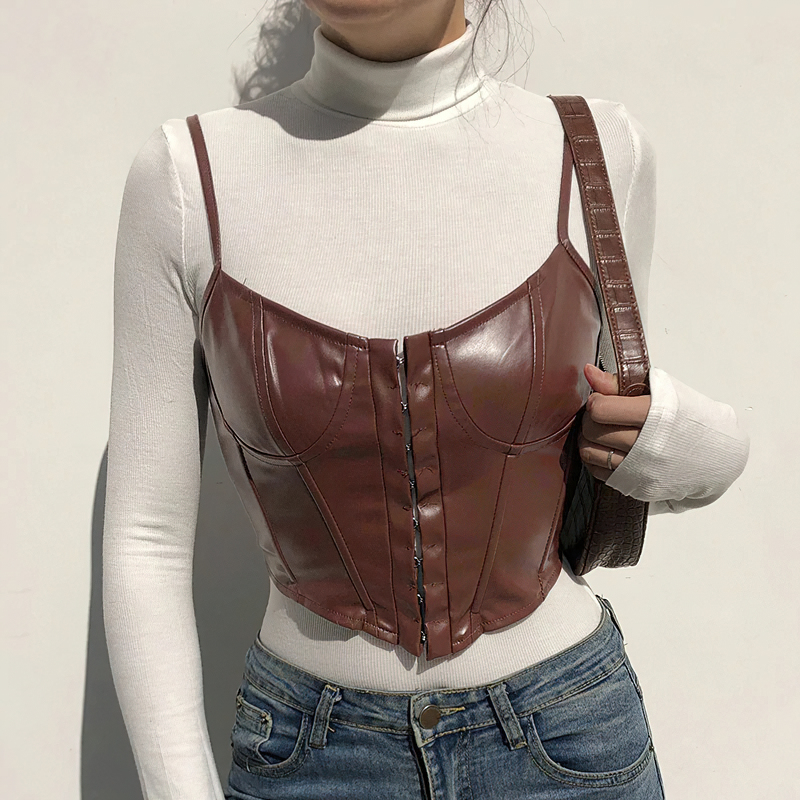 Fashionable PU leather sleeveless corset crop top paired with a white turtleneck, showcasing trendy style.