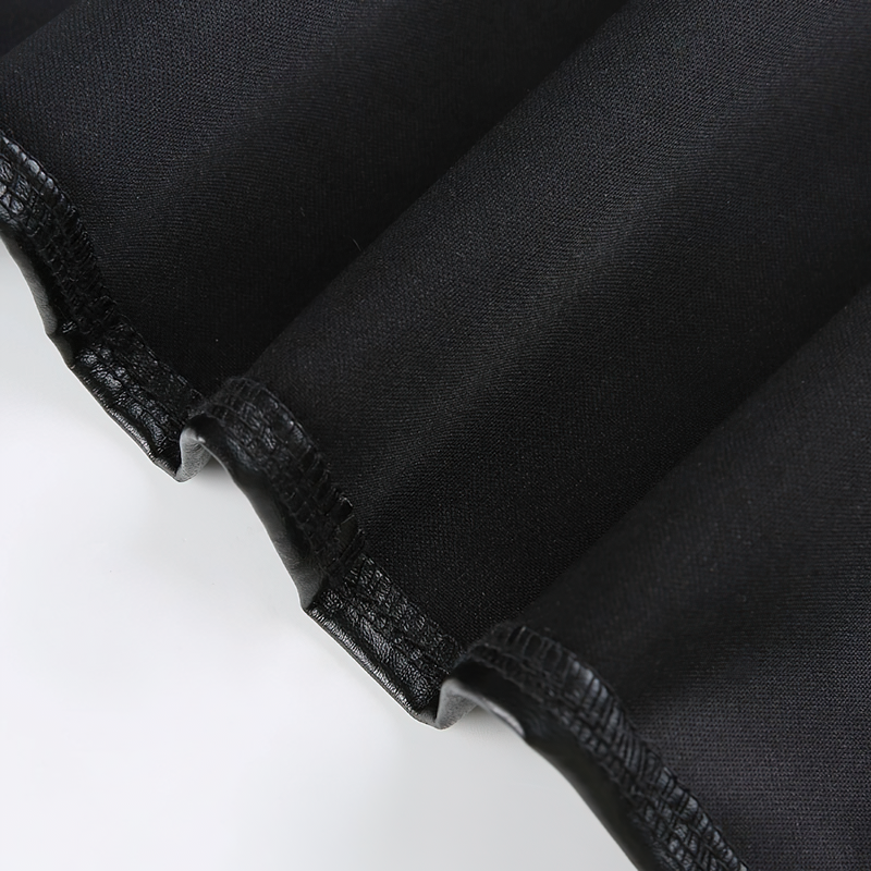 Close-up of shiny black PU leather fabric showcasing the texture and smooth finish for stylish outfits.